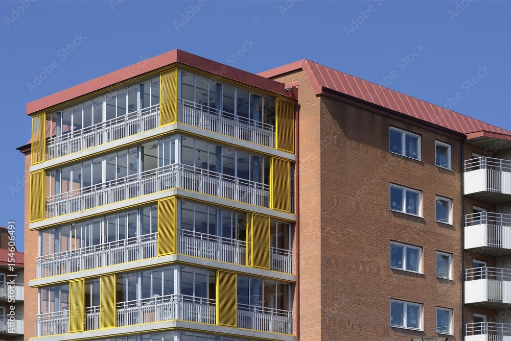 Windows and balconies with blue sky.