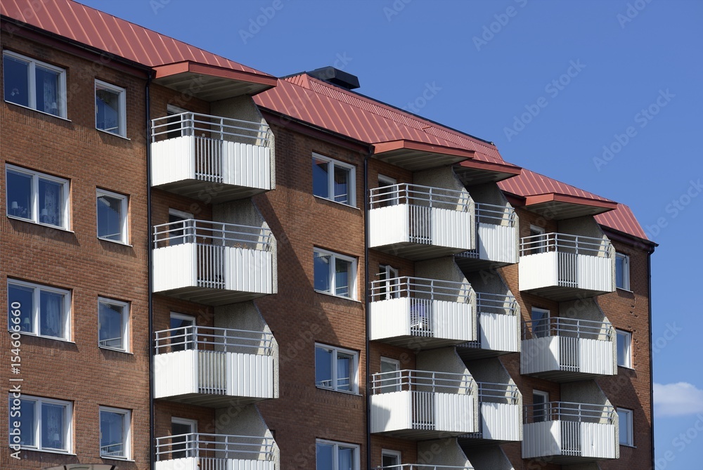 Windows and balconies with blue sky.