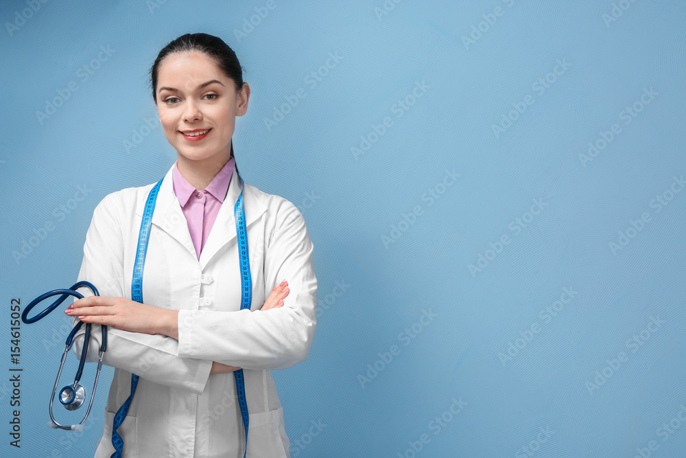 Portrait of young female nutritionist on light background Portrait of young female nutritionist on light background