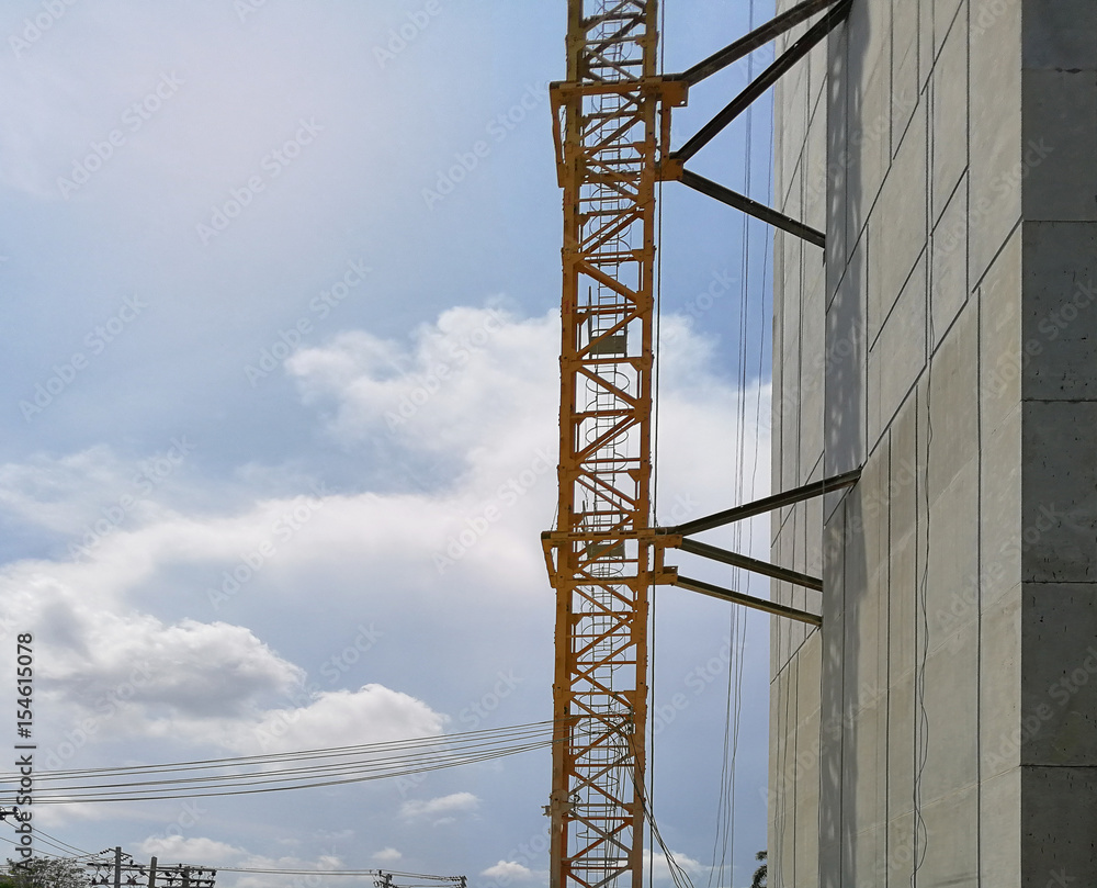 Construction cranes machine against sky background. Under construction of high-rise residential building. Construction cranes machine against sky background. Under construction of high-rise residential building.