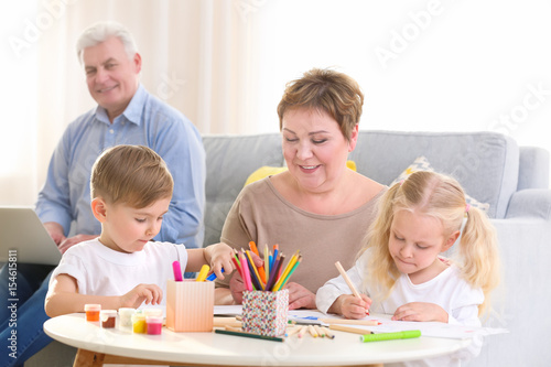 Happy senior woman painting...