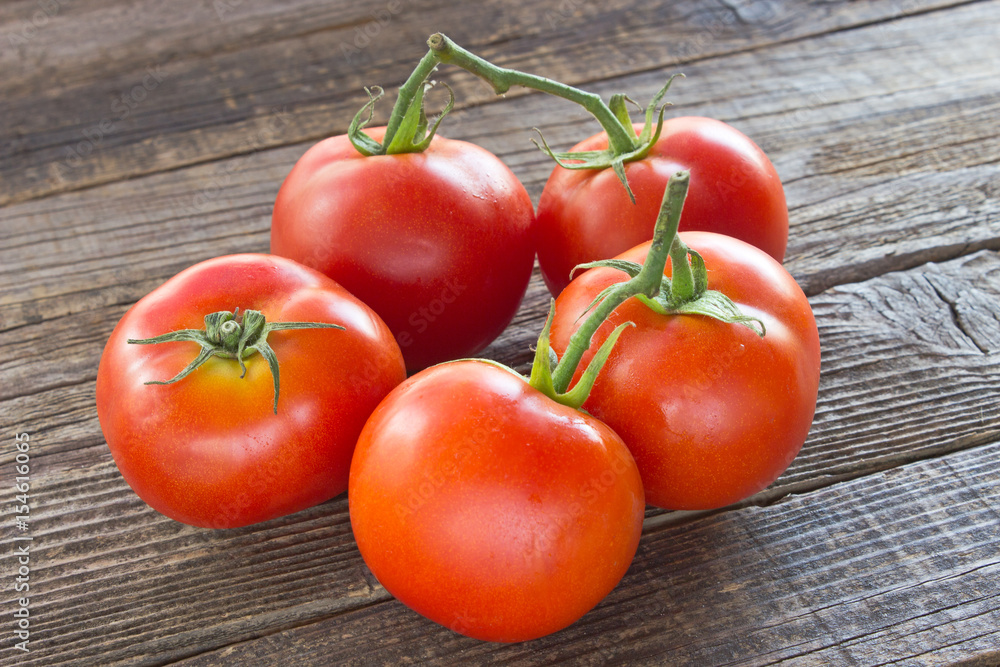 Tomatoes on old wooden background Tomatoes on old wooden background
