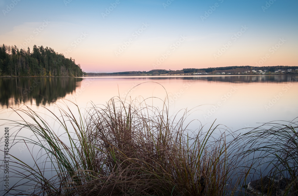 Scenic landscape with lake and sunset at autumn evening