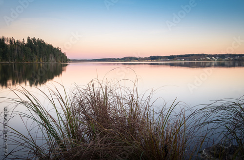 Scenic landscape with lake and sunset at autumn evening