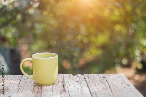 Green coffee cup On the wooden