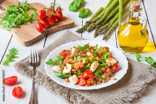 Healthy salad with cereals, asparagus and tomato