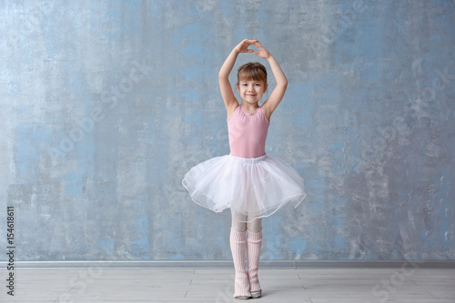 Cute little ballerina in dance studio