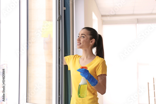 Young woman using detergent...