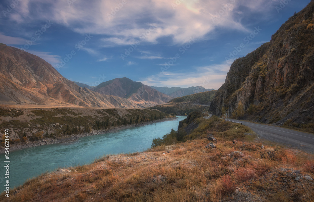 The picturesque autumn landscape with road along turquoise river