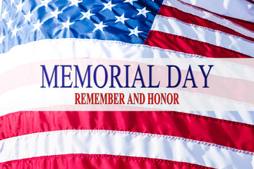 Text Memorial Day and Honor on flowing American flag background. Concept of Memorial day or Veteran's day in America.