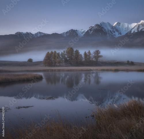 Misty autumn morning, a picturesque mountain lake