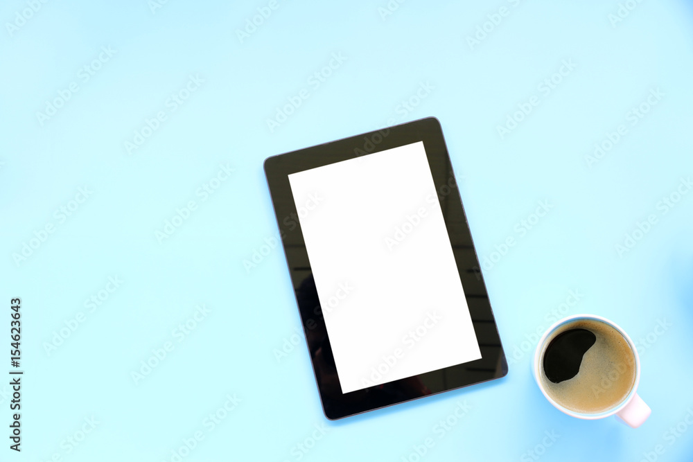 tablet and Hot coffee on blue background.copy space,Top view,flat lay tablet and Hot coffee on blue background.copy space,Top view,flat lay