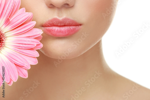 Beautiful young woman with flower on white background  closeup
