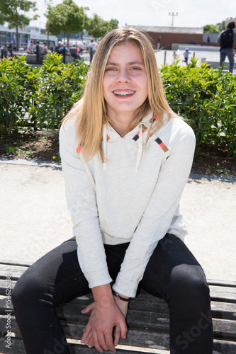 blond teenage girl in front of city skatepark photo