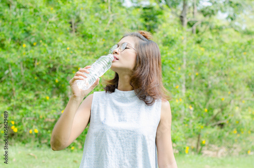 Asian women drinking water in nature and relax time on holiday.concept,