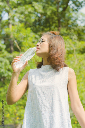 Asian women drinking water in nature and relax time on holiday.concept,