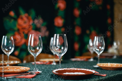 Wine glasses and table serving in rustic style restaurant