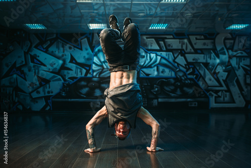 Young breakdance performer, upside down motion