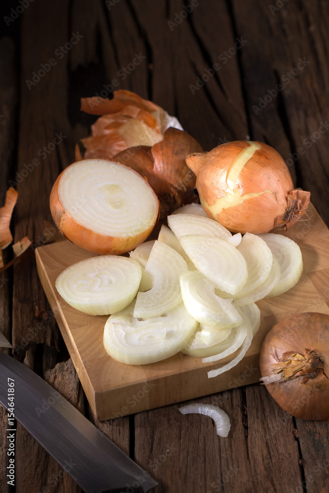 Sliced Fresh onion and Ripe onion on wooden background.