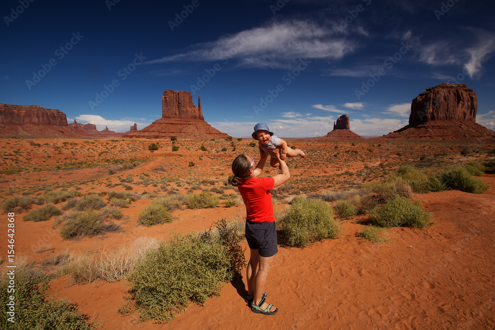 Mother with her baby son visit Oljato Monument Valley in Utah, USA