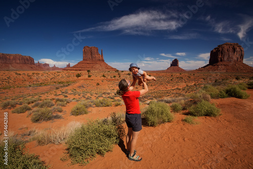 Mother with her baby son visit Oljato Monument Valley in Utah, USA