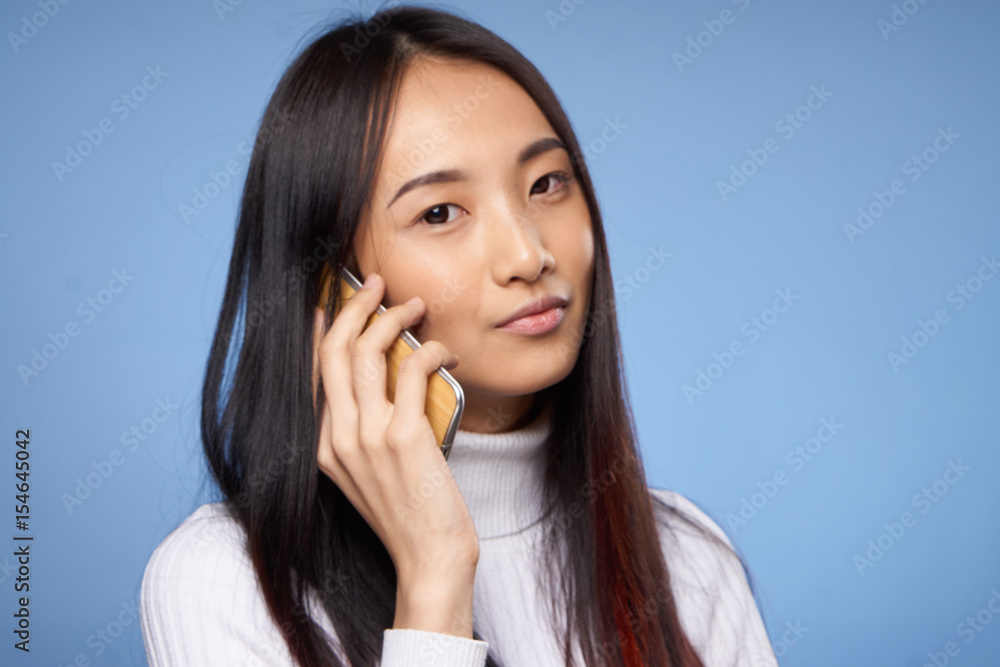 a woman in a sweater is talking on the phone a woman in a sweater is talking on the phone
