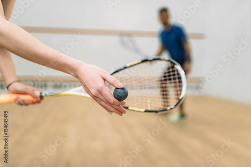 Fotografi Couple play squash game in indoor training club