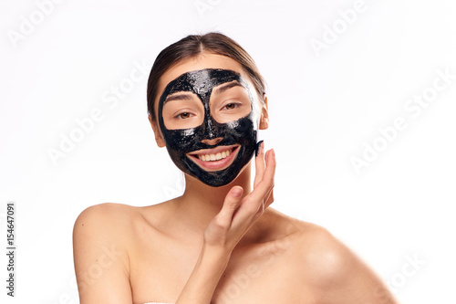 happy woman with a rejuvenating black mask