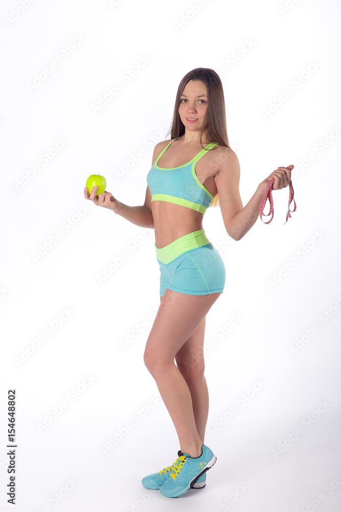 Slim sports woman with apple and measuring tape Slim sports woman with apple and measuring tape