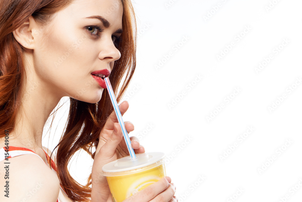 red-haired lady with red lips drinking freshly squeezed juice red-haired lady with red lips drinking freshly squeezed juice
