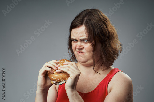 a woman with a burger, emotions, bad food