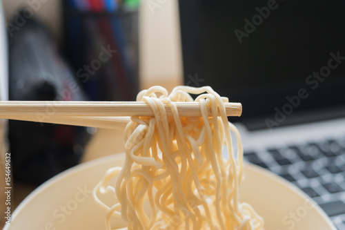 Some people eat noodles during work
