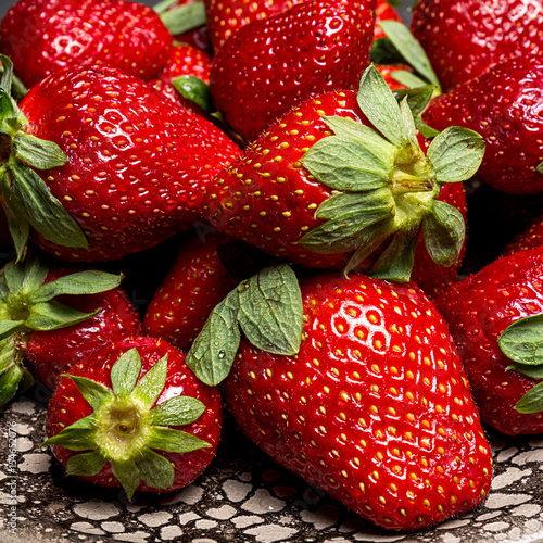 fresh ripe useful fruit strawberry in a clay bowl closeup 