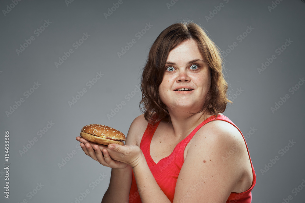 cheerful woman with a hamburger, meal. fast food cheerful woman with a hamburger, meal. fast food