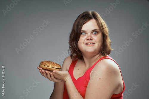 cheerful woman with a hamburger, meal. fast food