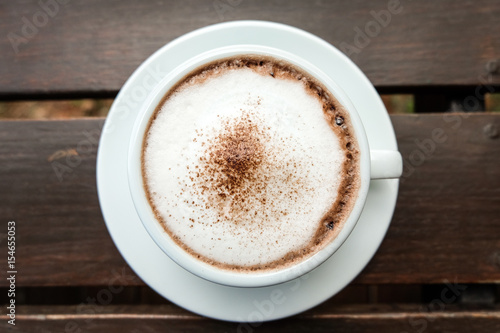 hot cocoa and milk foam on wooden table