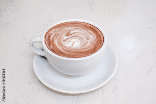 hot cocoa and milk foam on wooden table
