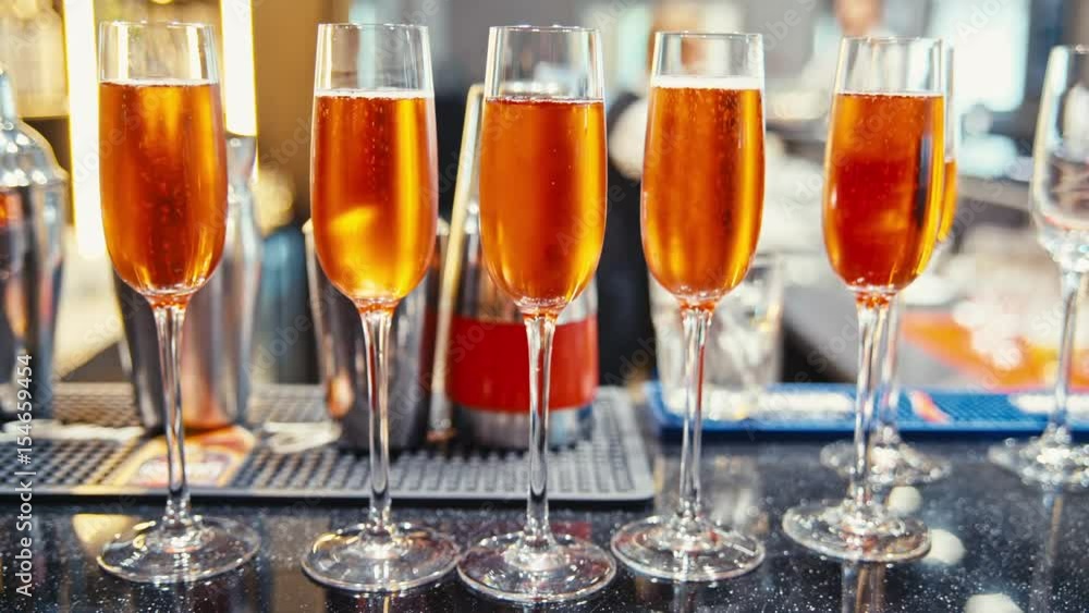 the champagne glasses are on the bar. the champagne glasses are on the bar.