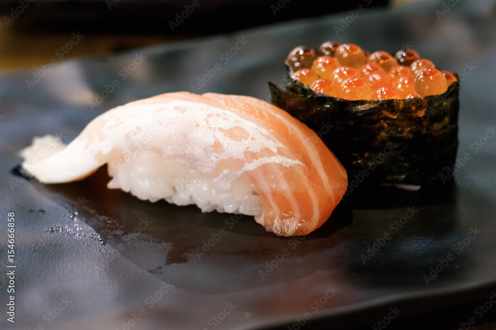 Sushi on plate in the restaurant, Japanese traditional food. Sushi on plate in the restaurant, Japanese traditional food.
