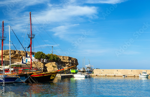 Port of Hersonissos with Boats in Blue Water and Hills on the Background, Crete Island, Greece photo