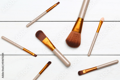 Make up brushes on wooden white desk