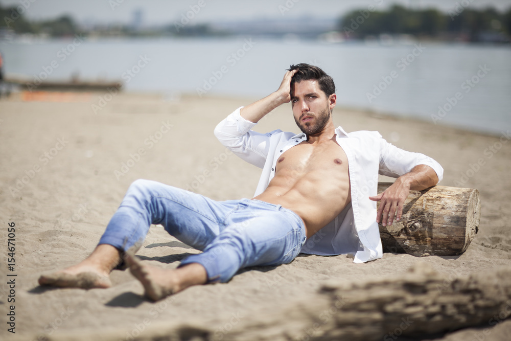 young sexy man on a beach,shallow depth of field