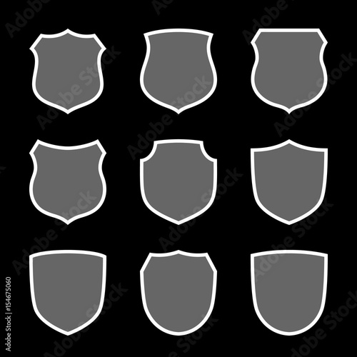 Shield shape icons set. Gray label signs isolated on black background. Symbol of protection, arms, security, safety. Flat retro style design. Element vintage heraldic emblem Vector illustration