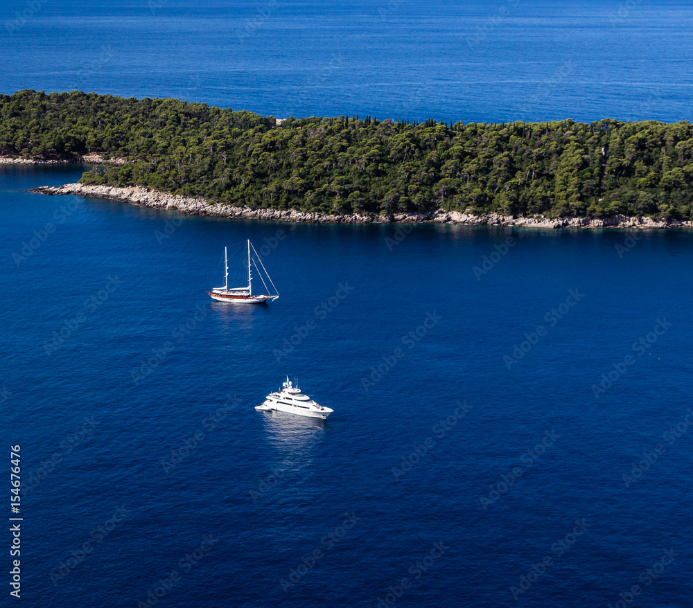 Sailboat and yatch beside Lokrum island in Dubrovnik Mediterranean coast, Croatia