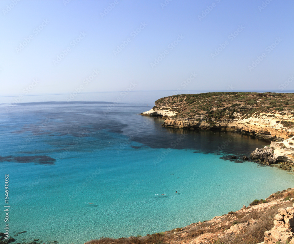 Pure crystalline water surface around an island - Lampedusa, Sicily Pure crystalline water surface around an island - Lampedusa, Sicily