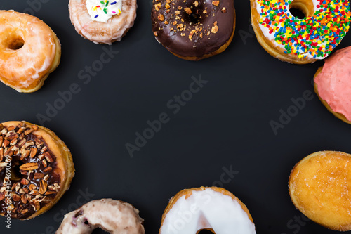 Fotografia, Obraz Assorted donuts on a black background