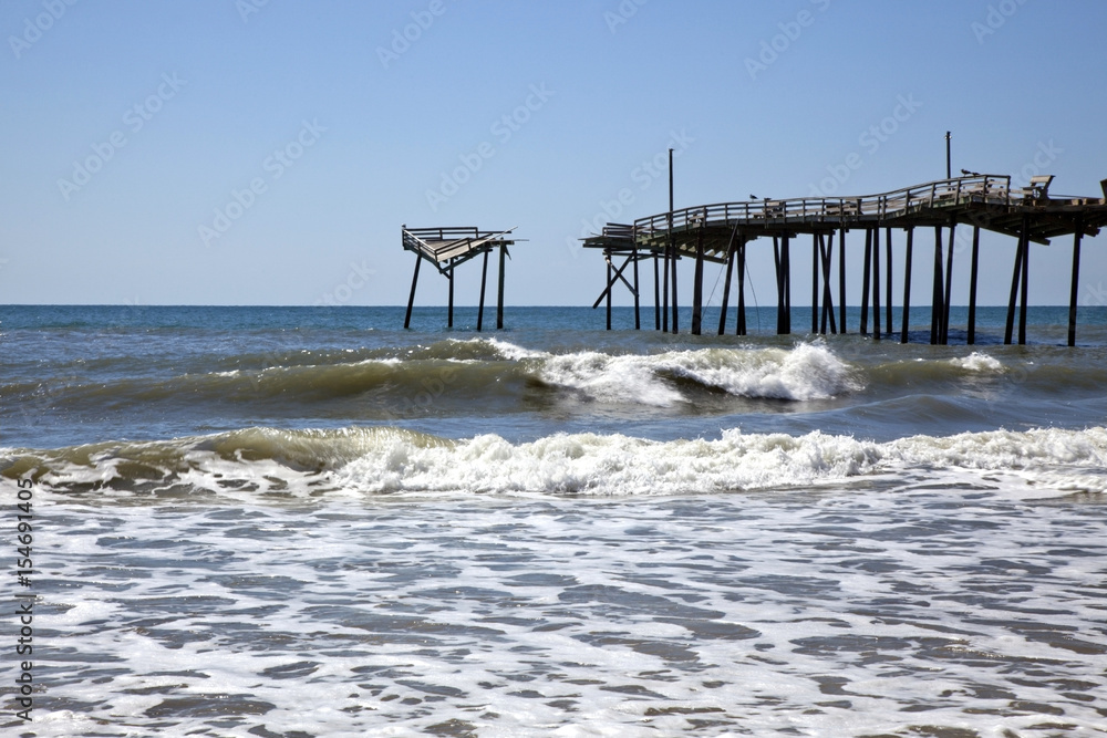 North Carolina coastal landscape with derelict pier and surf.