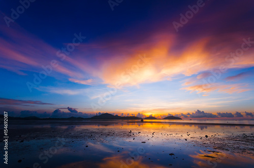 Harbor at dawn before sunrise in the morning created a colorful blue, purple and orange scenics in Sapanhin, Phuket island Thailand