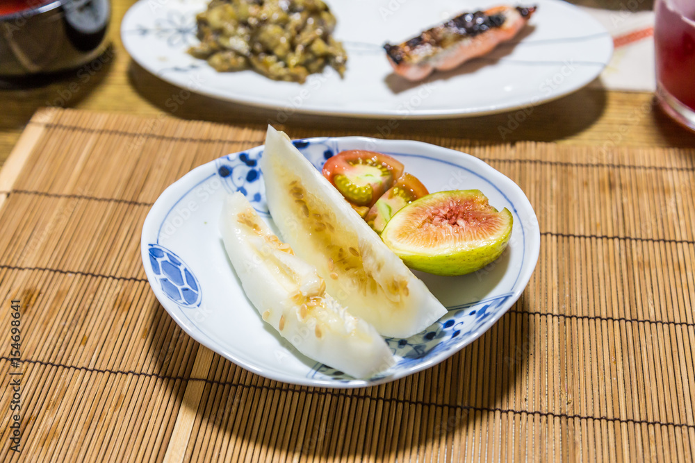 Fresh fruits after breakfast - honeydew melon, fig and tomato. Fresh fruits after breakfast - honeydew melon, fig and tomato.