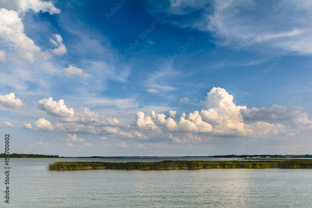 clouds on the blue sky gathering over the lake